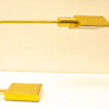 Sleek gold desk lamp with geometric prism design, adjustable arm, and sturdy base for modern decor.