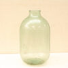 Charming vintage green glass jar with a bulbous shape and rustic character for home decor.