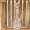 Elegant crystal decanter in rustic wooden crate, showcasing beauty and craftsmanship.