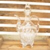 Elegant glass decanter with intricate etched floral designs, perfect for sophisticated decor.