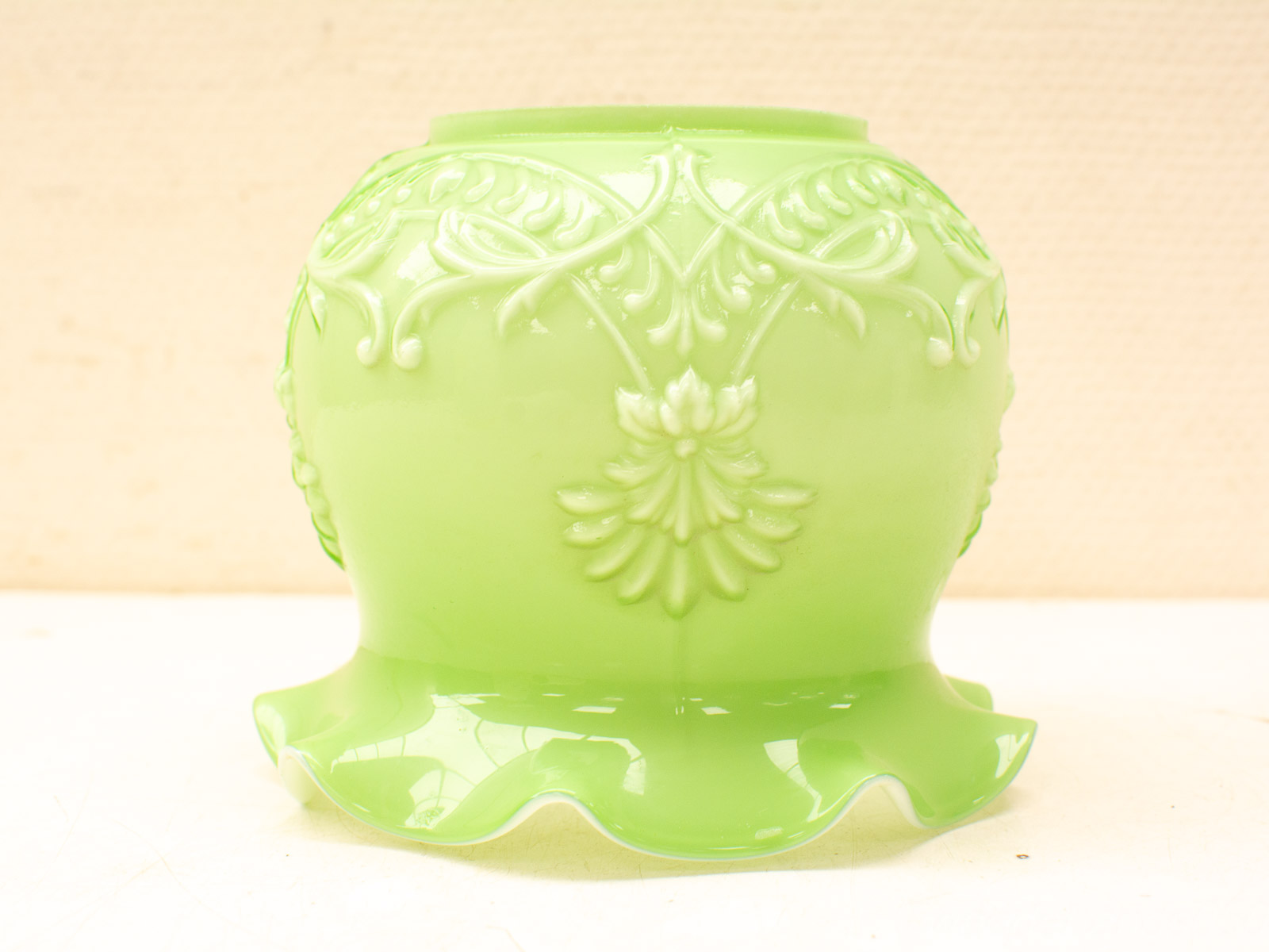 Elegant green glass vase with floral motifs, perfect for enhancing any decor style.