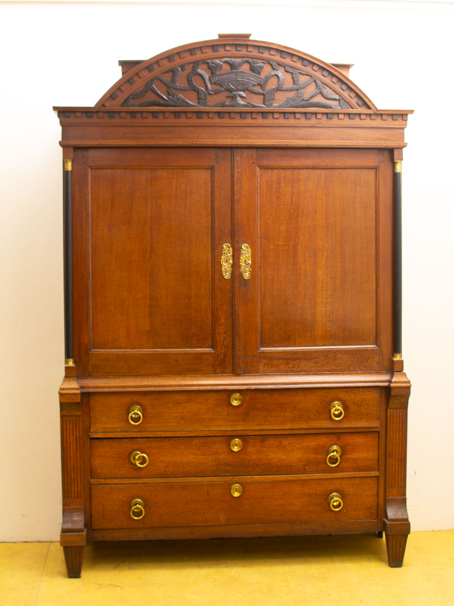 Elegant mahogany cabinet with intricate carvings, double doors, and spacious drawers for timeless appeal.