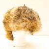 Vintage brown fur hat with ear flaps, combining warmth and style for winter outings.