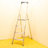 Stylish four-step aluminum ladder with paint splatters, ideal for DIY projects and practical use.