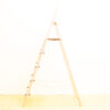 Simple wooden A-frame ladder against a bright white background, emphasizing minimalist design and functionality.