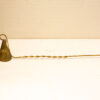 Elegant vintage brass candle snuffer with decorative designs, perfect for antique decor enthusiasts.