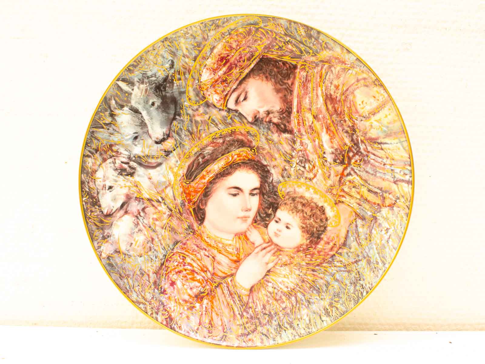 Tender family scene of mother and child on a vibrant decorative plate.
