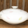 Elegant porcelain casserole with pastel leaf design, perfect for serving meals and enhancing decor.