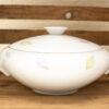 Elegant porcelain casserole dish with delicate pastel motifs, perfect for any dining occasion.