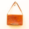 Timeless brown vintage leather bag with metal details, perfect for casual or formal occasions.