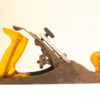 Vintage hand plane with yellow handle, showcasing fine craftsmanship for woodworking enthusiasts.