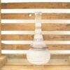 Elegant glass vase with rustic wooden backdrop, perfect for sophisticated home decor.