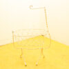Elegant vintage oval wire basket with a curved handle, perfect for decor and storage.