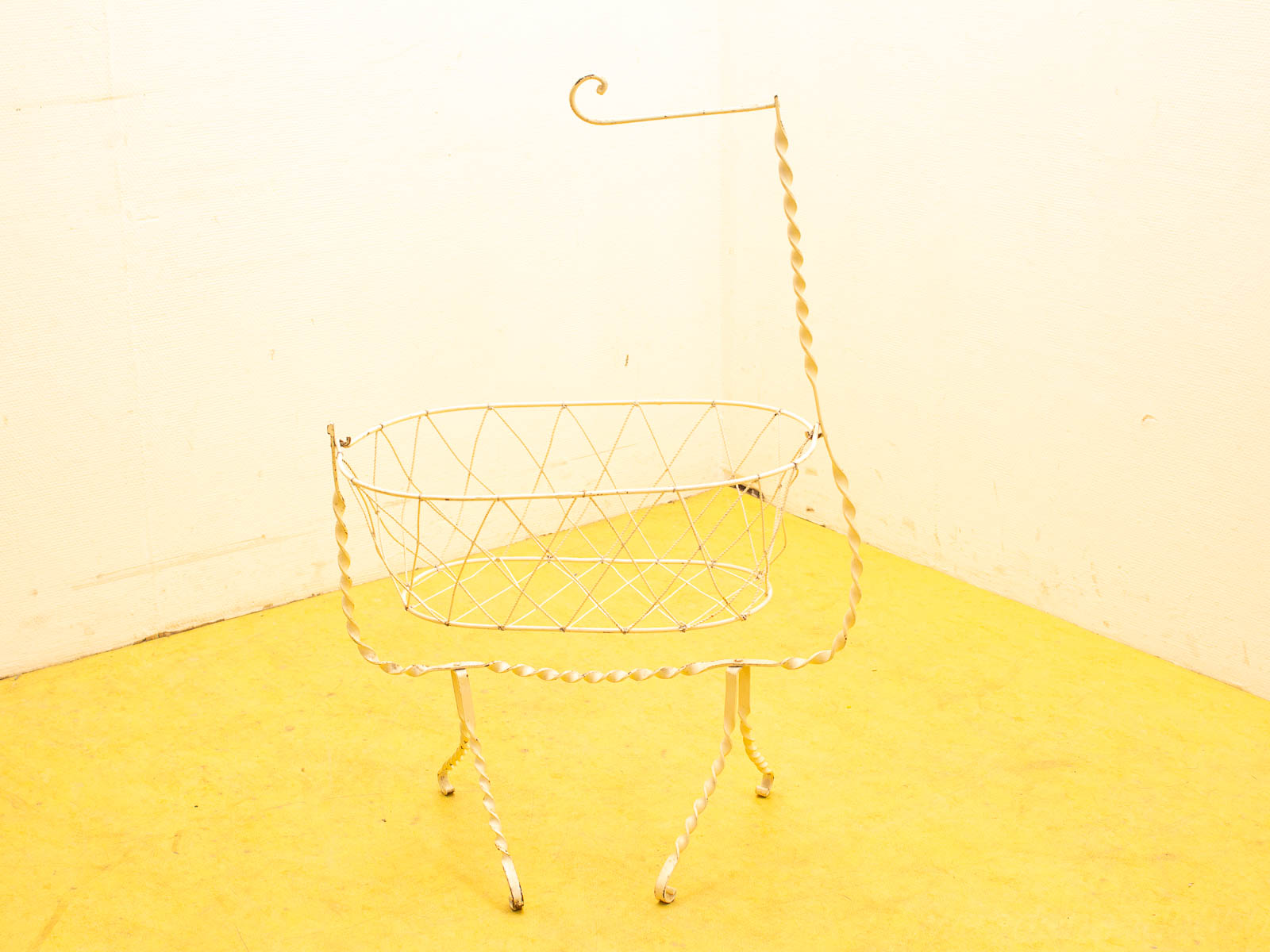 Elegant vintage oval wire basket with a curved handle, perfect for decor and storage.