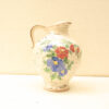 Elegant vintage ceramic pitcher with vibrant floral designs, perfect for decor and collectors.