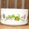 Elegant ceramic planter with vibrant floral designs, perfect for plants or stylish decor.