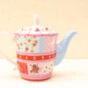 Whimsical vintage floral teapot with vibrant patterns, perfect for cozy tea parties and collectors.