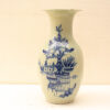 Elegant vintage vase with pastel green glaze and intricate blue floral designs. Perfect decor piece.