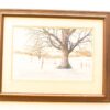 Tranquil winter landscape with a silhouetted tree, rustic buildings, and snowy fields.