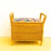 Charming wicker storage bench with floral cushion, perfect for seating and stylish organization.