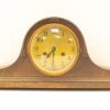 Elegant vintage tabletop clock with rich wood finish and intricate details, perfect for timeless decor.