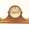 Elegant vintage wooden mantel clock with brass accents for classic home decor.