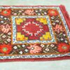 Vibrant maroon vintage rug with geometric and floral designs, adding warmth to any space.