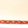 Vibrant red and beige vintage runner with intricate diamond-patterned design for elegant decor.