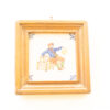 Charming vintage artwork of a tradesman with a bird in a rustic wooden frame.