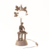 Vintage lamp with boy sculpture and natural leaf details, perfect for cozy, nostalgic spaces.