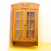 Charming vintage wooden cabinet with glass doors, perfect for displaying collectibles and adding warmth.