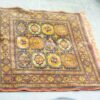 Vibrant vintage woven rug with geometric patterns in warm colors, perfect for enhancing any space.