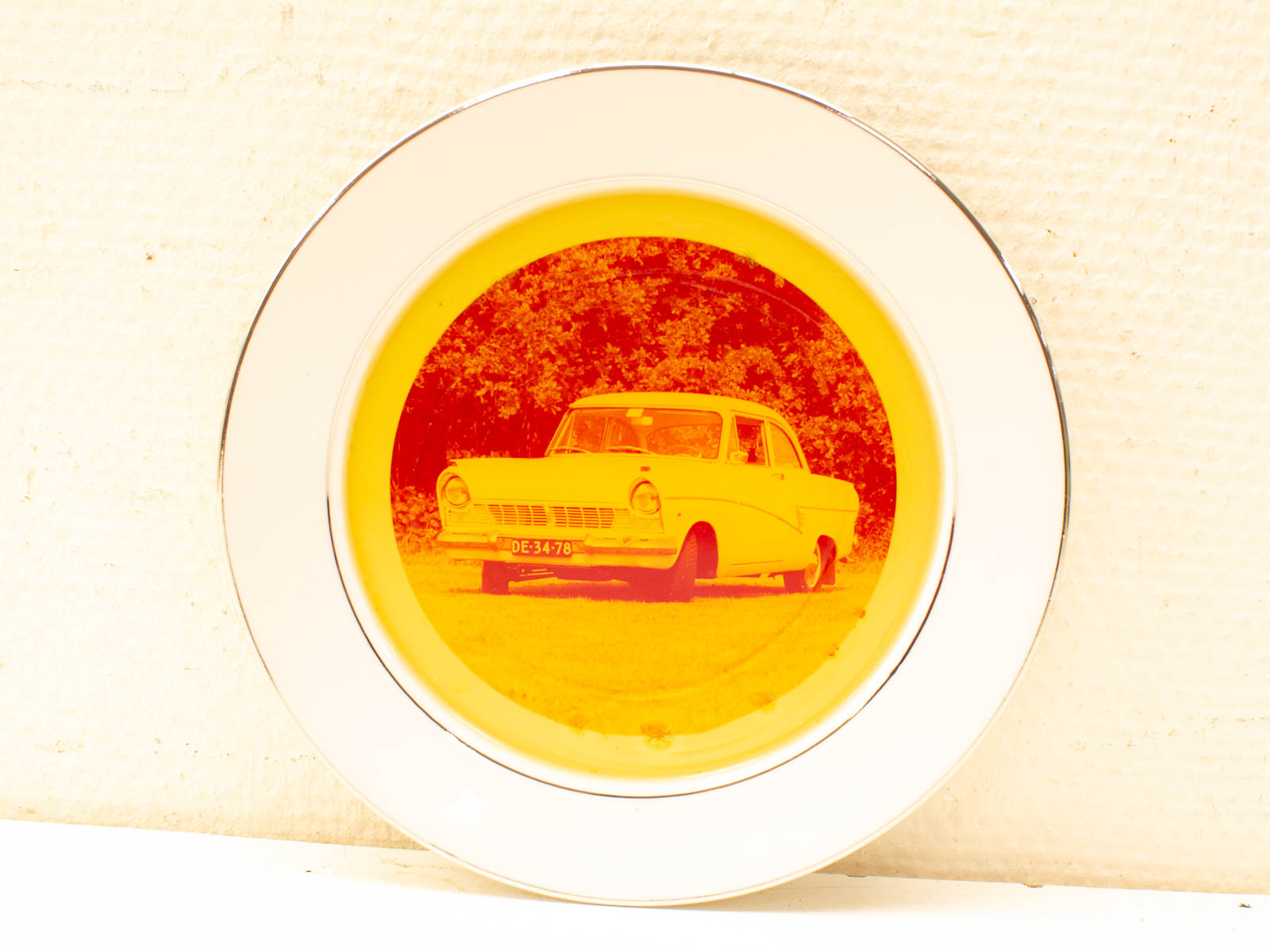 Vintage car plate with warm hues, elegant design, perfect for collectors and automotive enthusiasts.