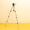 Sturdy aluminum photography tripod with adjustable legs and quick-release plate for camera stability.