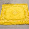 Vibrant yellow vintage rug with floral patterns, perfect for adding warmth to any room.