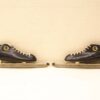 Classic vintage black leather ice skates with beige laces, perfect for winter sports enthusiasts.