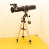 Sleek black telescope on sturdy tripod, ideal for stargazing and celestial observations.