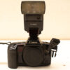 Vintage Canon EOS 10 camera with flash unit, perfect for photography enthusiasts and collectors.