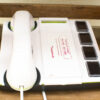 Nostalgic white and green telephone with user-friendly controls and service instructions.