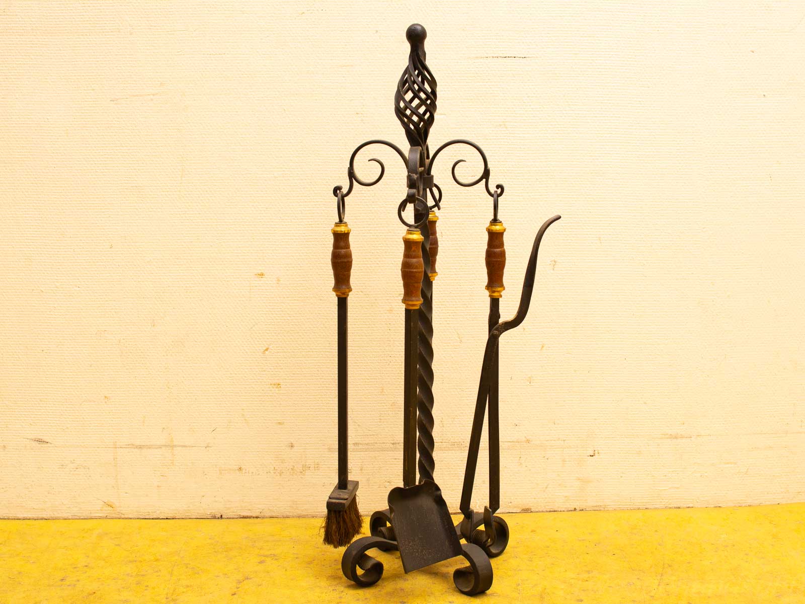 Elegant vintage fireplace tool set with wood accents for stylish and functional home decor.