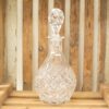 Elegant crystal decanter on a rustic wooden backdrop, showcasing fine craftsmanship and vintage charm.