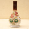 Elegant porcelain vase with intricate floral design and gold accents, perfect for home or gallery decor.