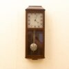 Stylish wooden wall clock with pendulum, blending classic elegance and modern design for any decor.