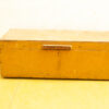Vintage yellow wooden storage box with rustic charm and signs of age, perfect for decor.