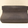 Handmade, dark matte ceramic pot with rustic modern aesthetics, suitable as a planter or decor piece.