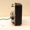 Vintage silver and black tape recorder showcasing retro audio technology on a neutral background.