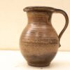 Elegant handcrafted ceramic jug in earthy tones, perfect for serving or decorative use.