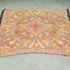 Vibrant vintage paisley shawl with elegant fringe, perfect for stylish layering and accessorizing.