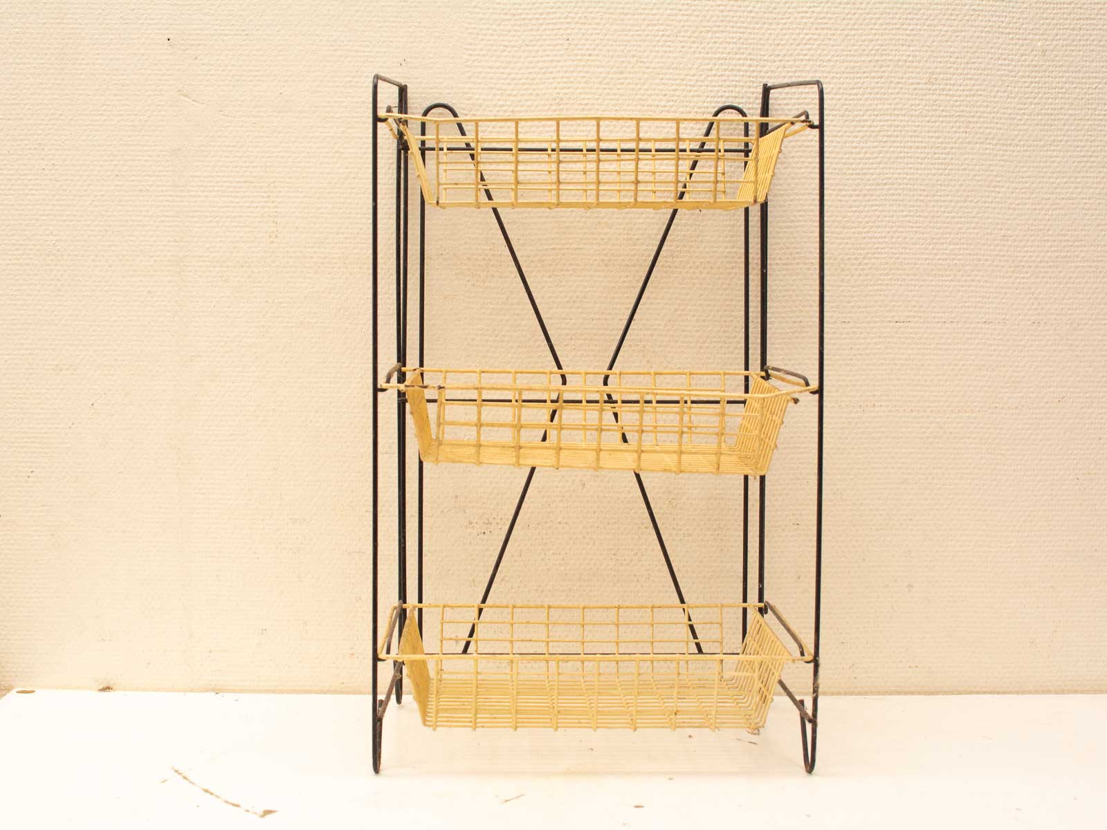 Vintage three-tier shelving unit with woven baskets for stylish and practical storage solutions.