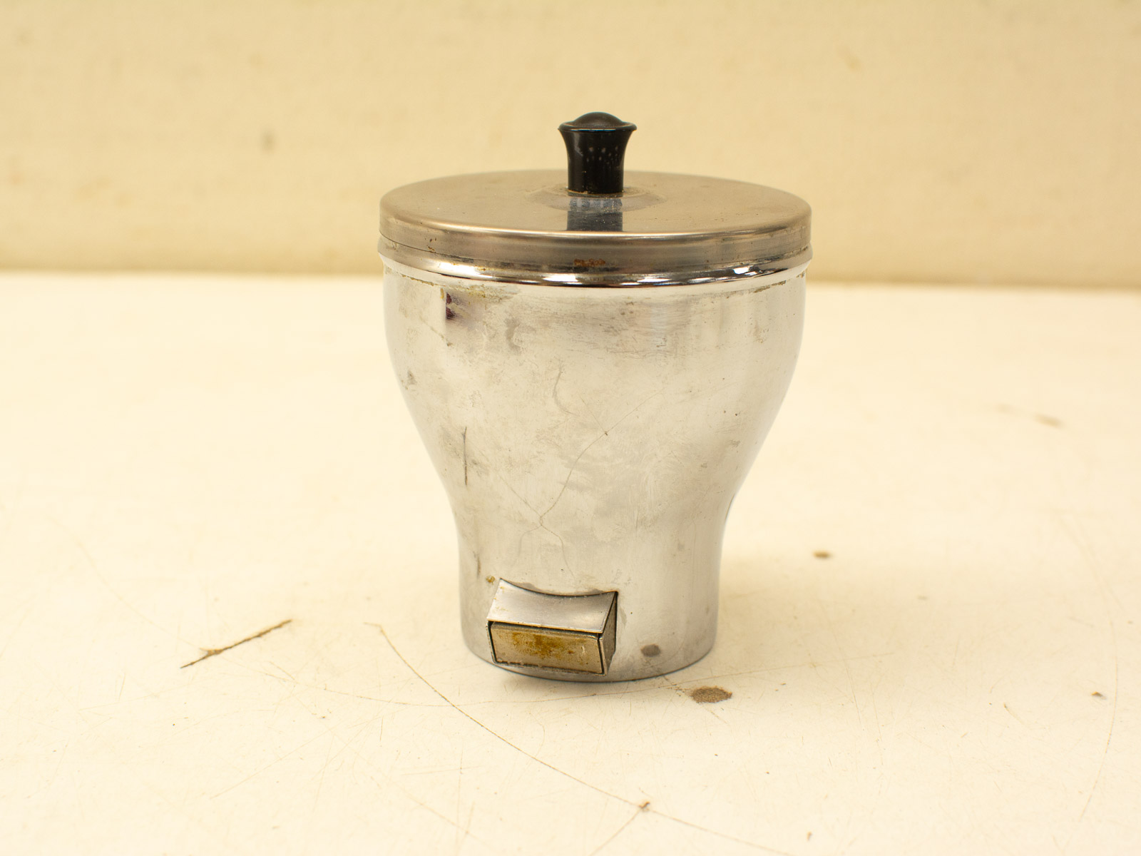 Vintage metallic container with dispensing mechanism, perfect for sugar or condiments in any kitchen.